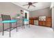 Covered outdoor kitchen equipped with a stainless steel grill, wooden cabinetry, and a cozy dining area at 1355 Hibiscus Ave, Winter Park, FL 32789