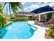 Sparkling pool with lounge chairs and umbrella, set against a backdrop of a well-manicured backyard and home at 1355 Hibiscus Ave, Winter Park, FL 32789