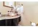 Powder room boasts a glass vessel sink, granite counter, and decorative accents at 1355 Hibiscus Ave, Winter Park, FL 32789