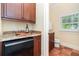 Wet bar features wine storage, dark cabinets, and granite countertops at 1355 Hibiscus Ave, Winter Park, FL 32789