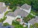 Aerial view of home with a two-car garage, screened-in patio, and patio with tiki umbrella at 1438 Stickley Ave, Celebration, FL 34747