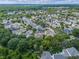 Aerial view of a neighborhood with lush trees and a house in the center of the image at 1438 Stickley Ave, Celebration, FL 34747