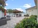 Backyard with tiki bar, outdoor kitchen, and seating area surrounded by lush greenery at 1438 Stickley Ave, Celebration, FL 34747