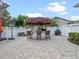 Outdoor tiki bar with seating and a basketball hoop in a spacious fenced backyard at 1438 Stickley Ave, Celebration, FL 34747