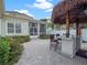 Backyard featuring a tiki bar, outdoor kitchen, pavers, and lush landscaping at 1438 Stickley Ave, Celebration, FL 34747