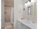 Bright bathroom featuring a single sink vanity, a mirror with lights, and a bathtub with a shower at 1438 Stickley Ave, Celebration, FL 34747