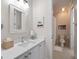 Elegant bathroom with white vanity, quartz countertop and view into the toilet and shower area at 1438 Stickley Ave, Celebration, FL 34747