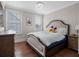 Comfortable bedroom featuring a cozy bed with a decorative headboard and hardwood floors at 1438 Stickley Ave, Celebration, FL 34747