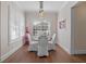 Cozy dining area features wood floors, bright windows, and stylish light fixture at 1438 Stickley Ave, Celebration, FL 34747