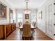 Elegant dining room with hardwood floors, decorative chandelier, wainscoting, and ample natural light at 1438 Stickley Ave, Celebration, FL 34747