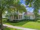 Charming two-story home featuring a double-decker front porch, beautiful landscaping and a manicured lawn at 1438 Stickley Ave, Celebration, FL 34747