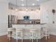 Charming kitchen bar with stone backsplash, stainless appliances, and pendant lighting at 1438 Stickley Ave, Celebration, FL 34747