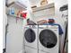 Well-organized laundry room with a front-load washer and dryer, shelves, and hanging rack at 1438 Stickley Ave, Celebration, FL 34747