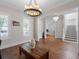 Bright living room featuring hardwood floors, plantation shutters, modern lighting, and an open floor plan at 1438 Stickley Ave, Celebration, FL 34747