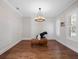 Bright living room featuring hardwood floors, plantation shutters, and a modern chandelier at 1438 Stickley Ave, Celebration, FL 34747