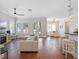 Open-concept living space featuring hardwood floors, comfortable seating, and natural light at 1438 Stickley Ave, Celebration, FL 34747