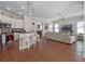 Spacious, open-concept living space and kitchen with hardwood floors and modern features at 1438 Stickley Ave, Celebration, FL 34747