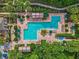 A resort style community pool offers ample lounge chairs and umbrellas surrounded by landscaping at 1438 Stickley Ave, Celebration, FL 34747