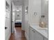 Stylish powder room with a white vanity and a view into a bedroom with hardwood floors at 1438 Stickley Ave, Celebration, FL 34747