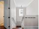 Bright staircase with white railings and wood steps, illuminated by a modern pendant light at 1438 Stickley Ave, Celebration, FL 34747