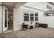 Inviting backyard patio with brick pavers, patio furniture, and a view of the home's interior through glass doors at 14390 Orchid Island Dr, Orlando, FL 32827
