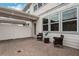 Cozy backyard patio area with brick pavers, stylish patio furniture, and white fencing at 14390 Orchid Island Dr, Orlando, FL 32827