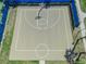 Overhead shot of fenced basketball court with blue accents at 14390 Orchid Island Dr, Orlando, FL 32827