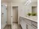 Modern bathroom with double sink vanity, framed mirror, and glass shower at 14390 Orchid Island Dr, Orlando, FL 32827
