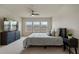 Well lit bedroom with a large tv, ceiling fan, and natural light at 14390 Orchid Island Dr, Orlando, FL 32827