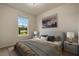 Cozy bedroom with a comfortable bed, stylish bedside tables, and bright natural light from the window at 14390 Orchid Island Dr, Orlando, FL 32827
