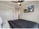 Bedroom with closet, ceiling fan and large TV for a relaxing and comfortable space at 14390 Orchid Island Dr, Orlando, FL 32827