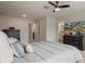 Spacious bedroom with ceiling fan, TV, and access to the bathroom at 14390 Orchid Island Dr, Orlando, FL 32827