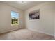 Vacant bedroom with neutral carpet, and a window providing ample natural light at 14390 Orchid Island Dr, Orlando, FL 32827