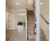 Open entryway with wood-look tile floors, view to living room, and staircase with wood and carpet at 14390 Orchid Island Dr, Orlando, FL 32827