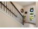 An entryway showcasing a staircase with elegant wrought iron railings and a front door with decorative wreath at 14390 Orchid Island Dr, Orlando, FL 32827