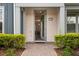 Inviting front entrance with a wreath on the door and well-maintained landscaping at 14390 Orchid Island Dr, Orlando, FL 32827