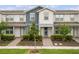 Charming two-story townhouse with a well-manicured lawn and inviting walkway leading to the front door at 14390 Orchid Island Dr, Orlando, FL 32827