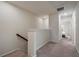 Upstairs hallway leading to bedrooms, featuring neutral carpeting and ample natural light from windows at 14390 Orchid Island Dr, Orlando, FL 32827