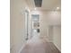 View of a hallway with access to bedrooms, neutral walls, and gray carpeting at 14390 Orchid Island Dr, Orlando, FL 32827