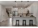 Modern kitchen with white cabinets, stainless steel appliances, pendant lighting, and breakfast bar seating at 14390 Orchid Island Dr, Orlando, FL 32827