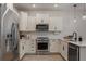 Bright kitchen featuring stainless steel appliances and sleek white cabinetry at 14390 Orchid Island Dr, Orlando, FL 32827