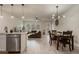 Open-concept living room with wood-look floors and a stylish dining area at 14390 Orchid Island Dr, Orlando, FL 32827