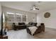 Comfortable living room featuring a large sectional sofa, wood-look tile flooring, and lots of natural light at 14390 Orchid Island Dr, Orlando, FL 32827