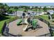 Community playground with slides and climbing structures surrounded by a fence at 14390 Orchid Island Dr, Orlando, FL 32827