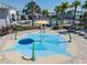Community splash pad with colorful design and playful water features for Gathering fun at 14390 Orchid Island Dr, Orlando, FL 32827