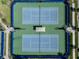 Aerial view of two blue and green fenced-in tennis courts at 14390 Orchid Island Dr, Orlando, FL 32827