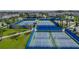 Several fenced tennis and pickleball courts in a neighborhood community at 14390 Orchid Island Dr, Orlando, FL 32827