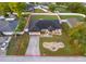 Aerial view of property with a well-manicured lawn, rock garden, and neutral-toned facade at 146 Hidden Pointe Ln, Groveland, FL 34736