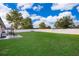 Expansive backyard featuring a well-maintained lawn, white vinyl fence, and patio area at 146 Hidden Pointe Ln, Groveland, FL 34736