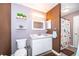 Charming bathroom featuring vanity, shelves with succulents and a unique patterned shower curtain at 146 Hidden Pointe Ln, Groveland, FL 34736